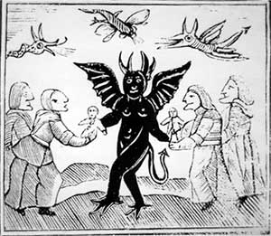 A woodcut of elderly witches meeting a black, winged devil while demons fly overheaad.