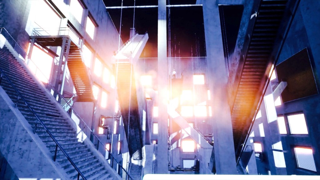 A large, grey interior space filled with concrete and metal stairways going in all directions, including upside-down.